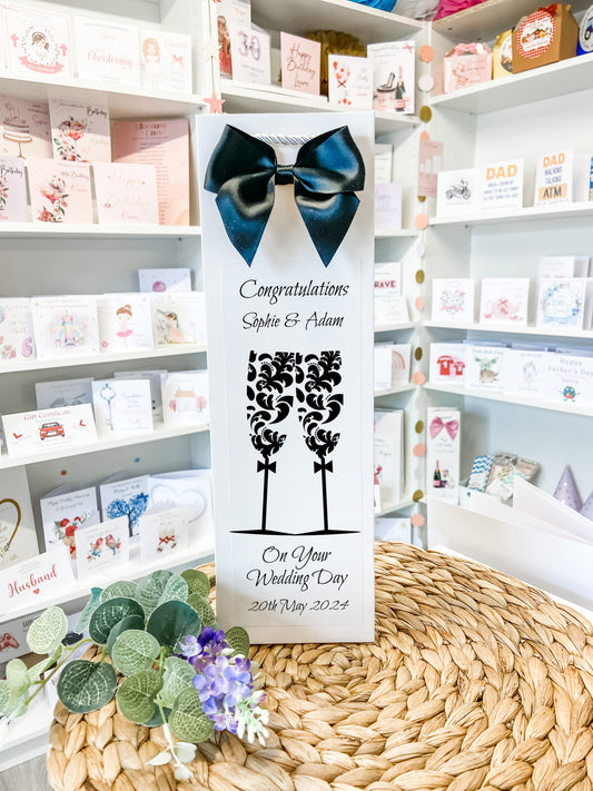 a white box with a blue bow on top of a table