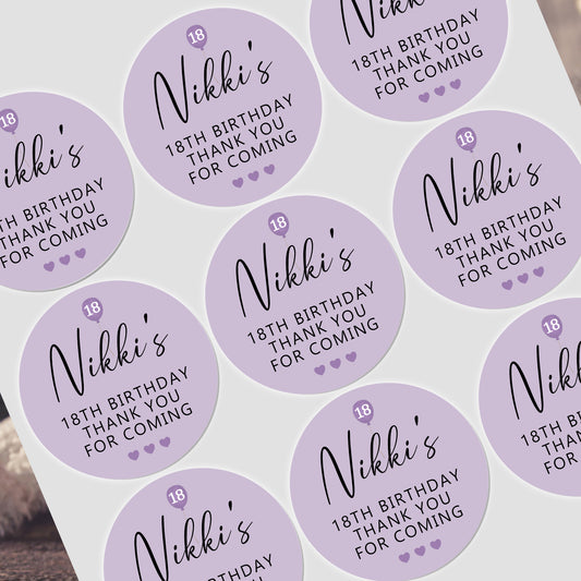 a table topped with lots of purple stickers