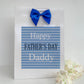 a father's day card with a blue bow