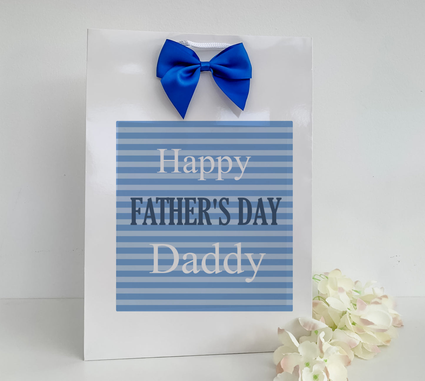 a father's day card with a blue bow