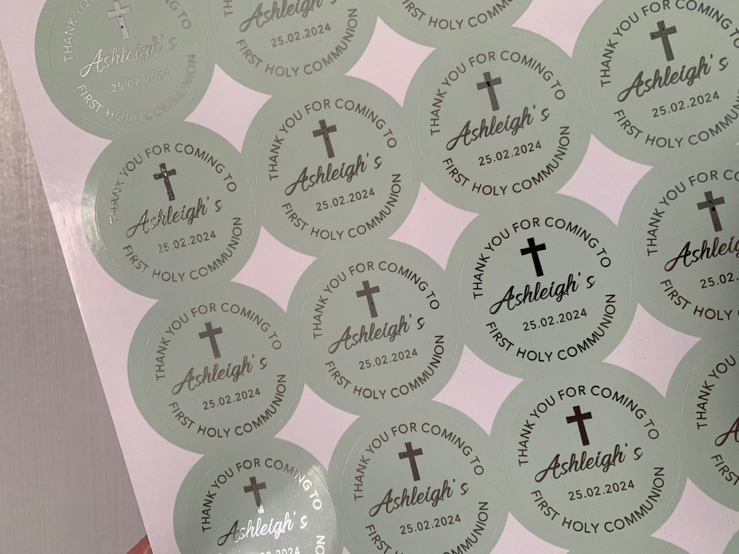 a person holding a sticker with a cross on it