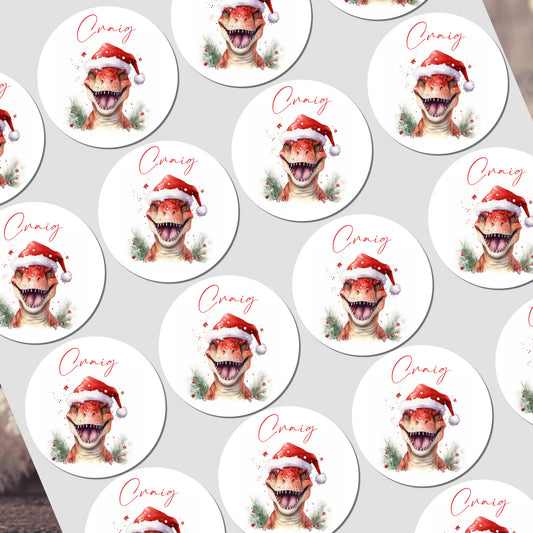 A sheet of stickers with a dinosaur wearing a Santa hat with personalised name