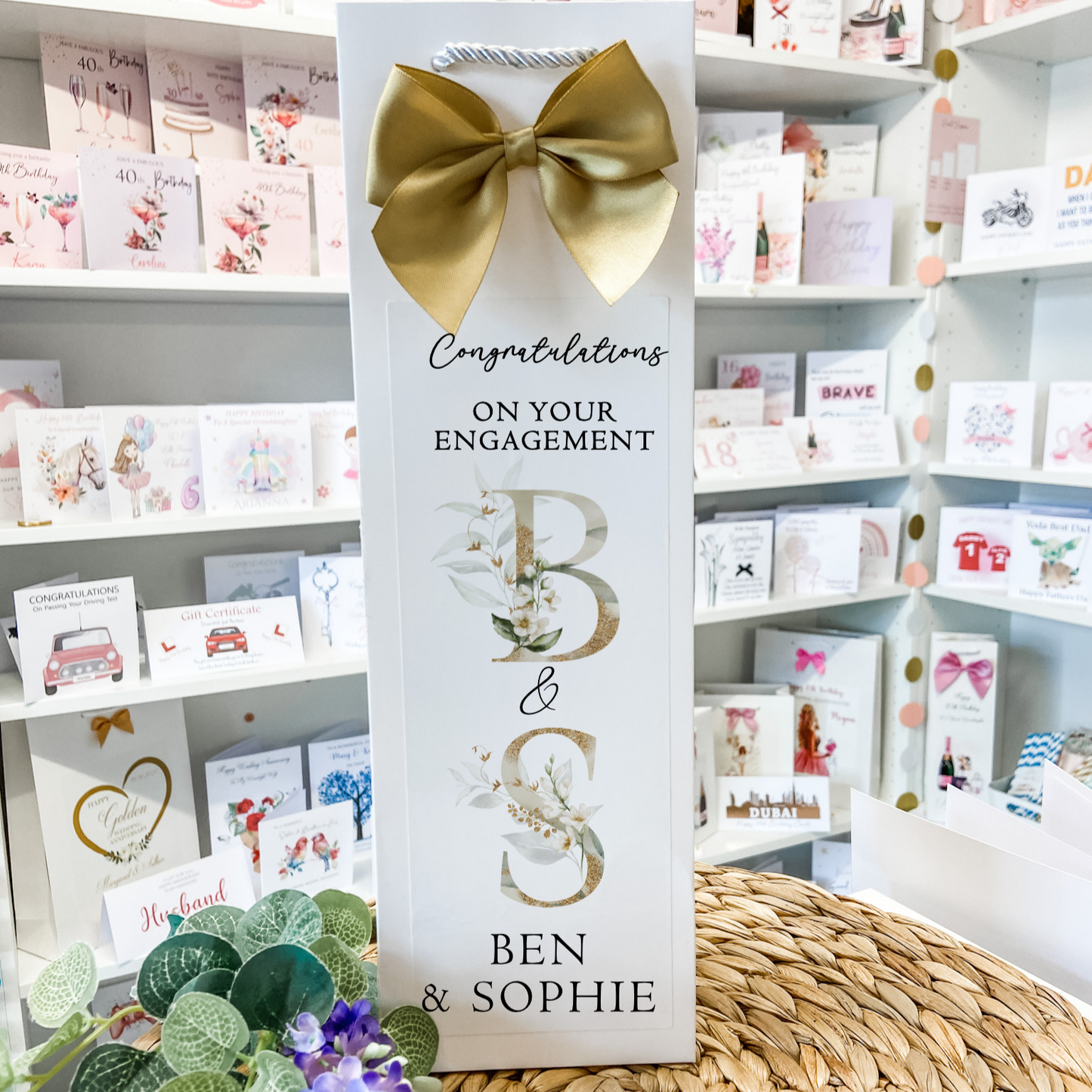 a card with a bow on top of a table