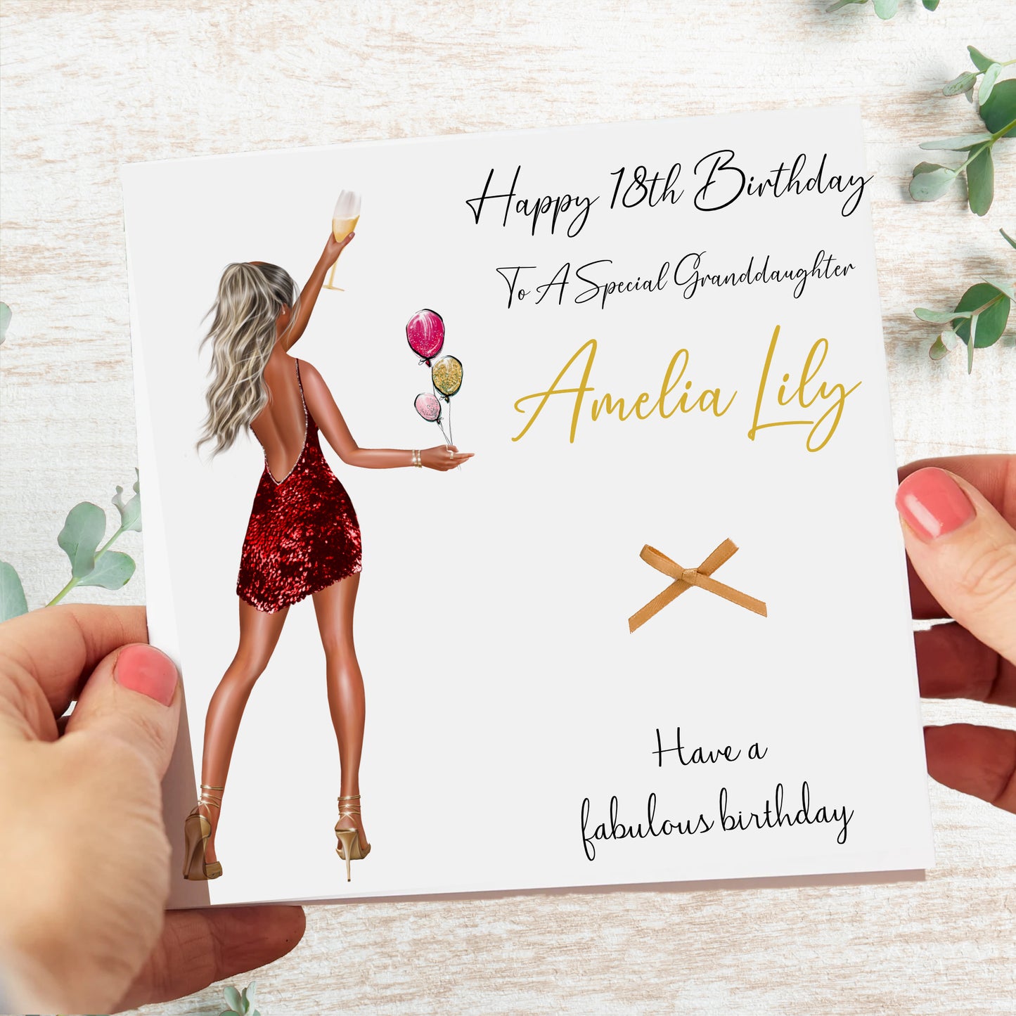 a person holding a birthday card with a picture of a woman