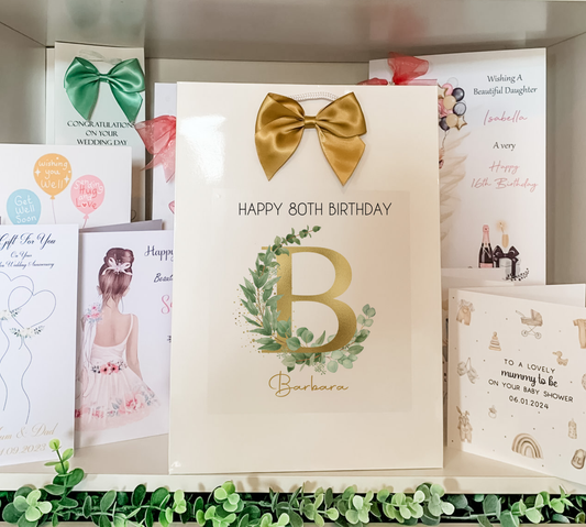 a birthday card with a gold bow on it