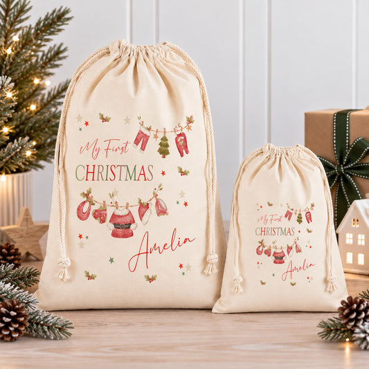 two beige drawstring bags with Christmas-themed designs, placed on a wooden surface.