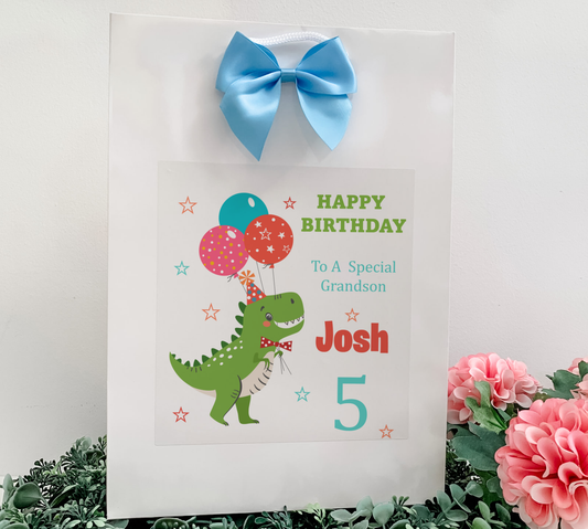 a birthday card with a dinosaur holding balloons