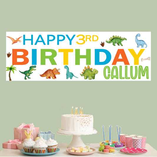 a birthday banner with a dinosaur theme