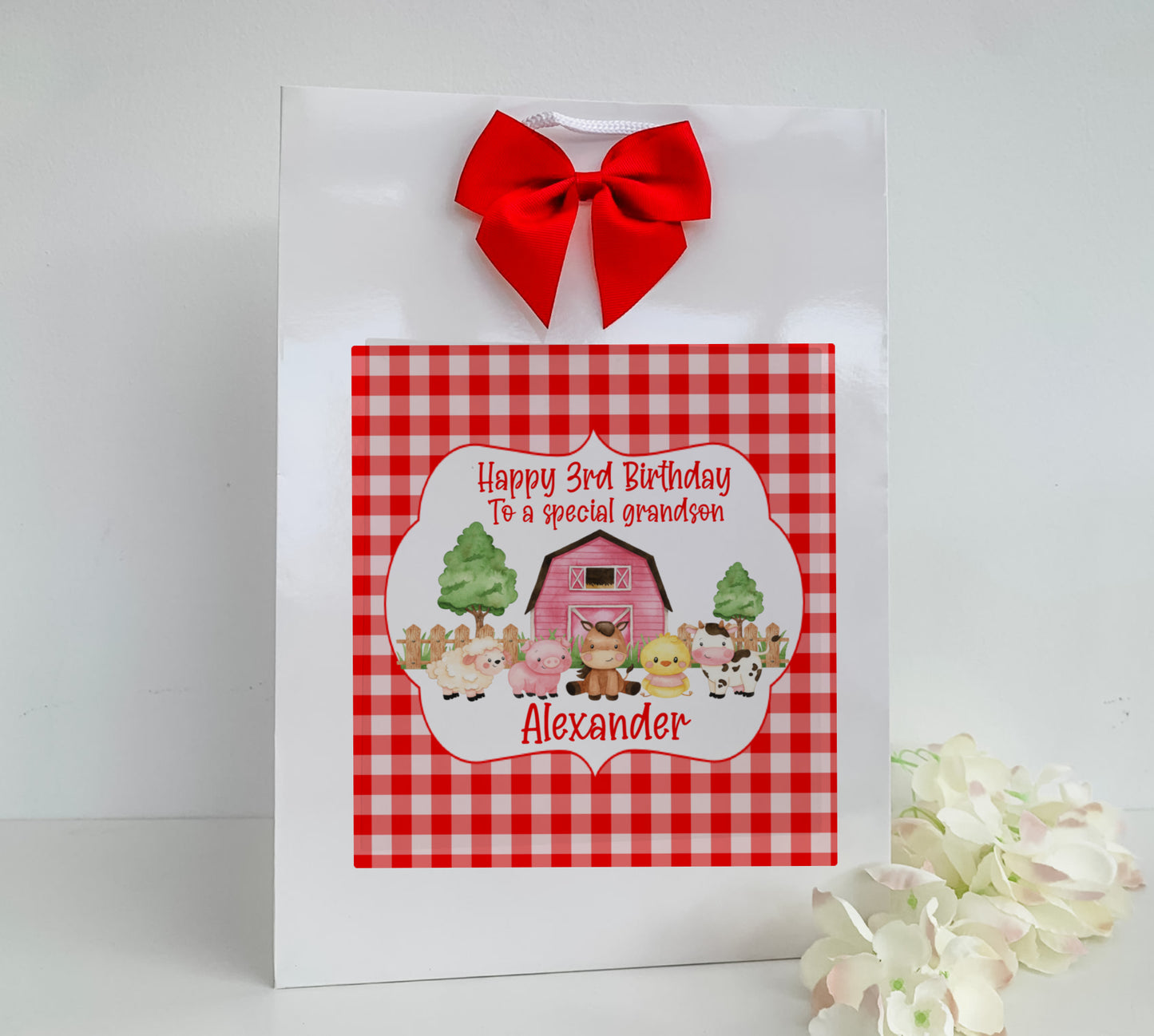 a red and white gingham bag with a red bow