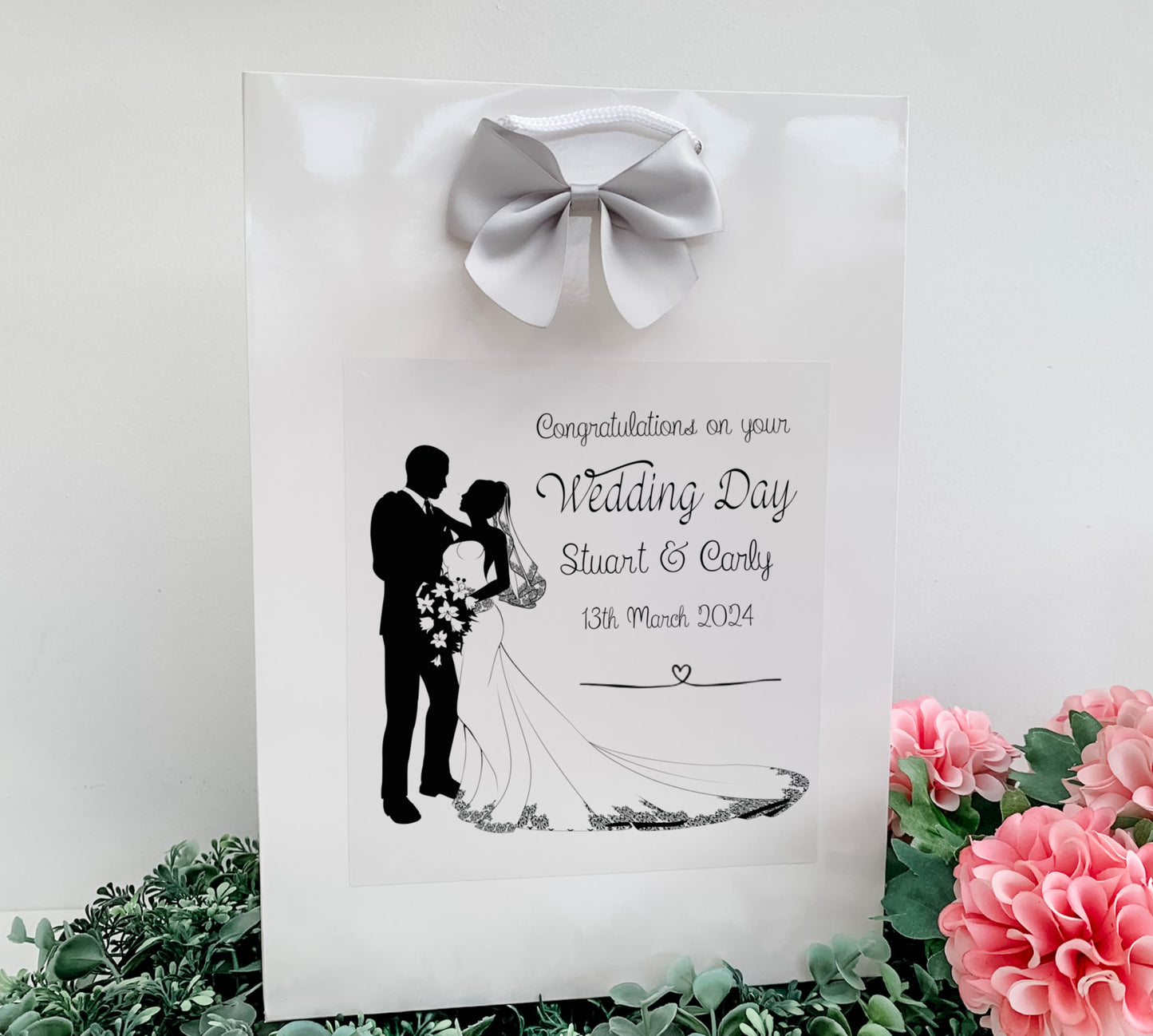 a paper bag with a picture of a bride and groom on it