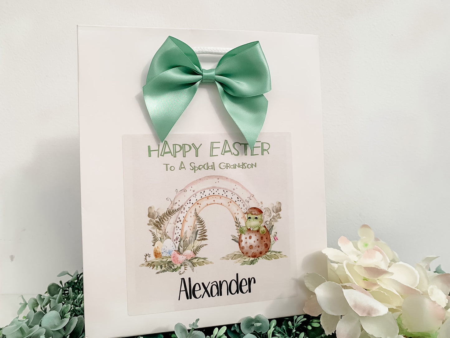 a happy easter card with a green bow