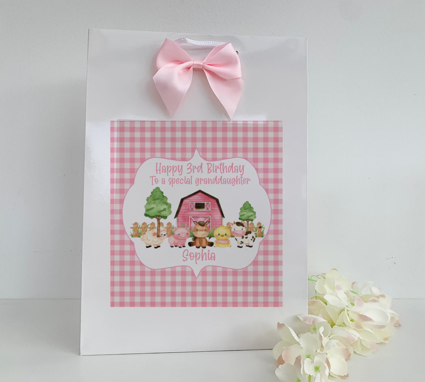 a pink and white bag with a pink bow on it