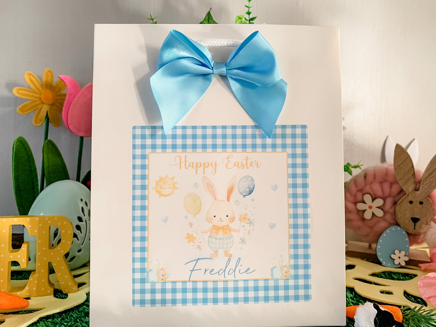 a happy easter card with a blue bow