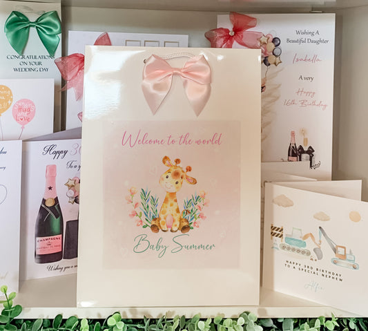 a card with a giraffe and a bow on it