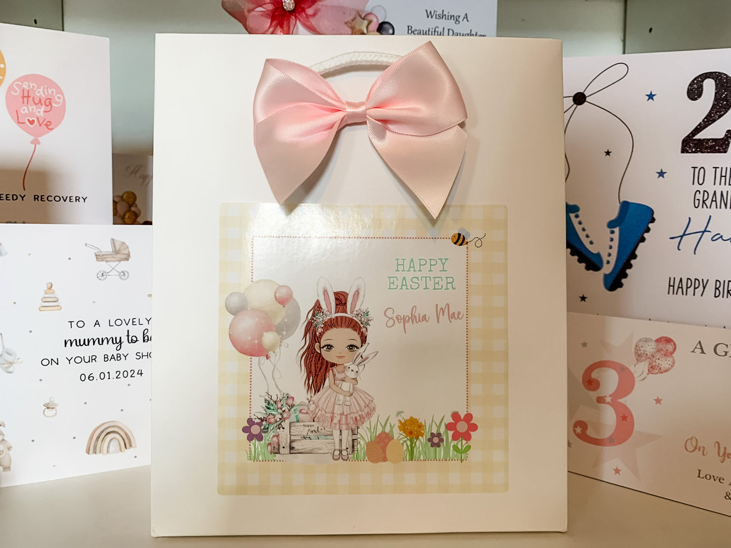 a card with a pink bow on top of it