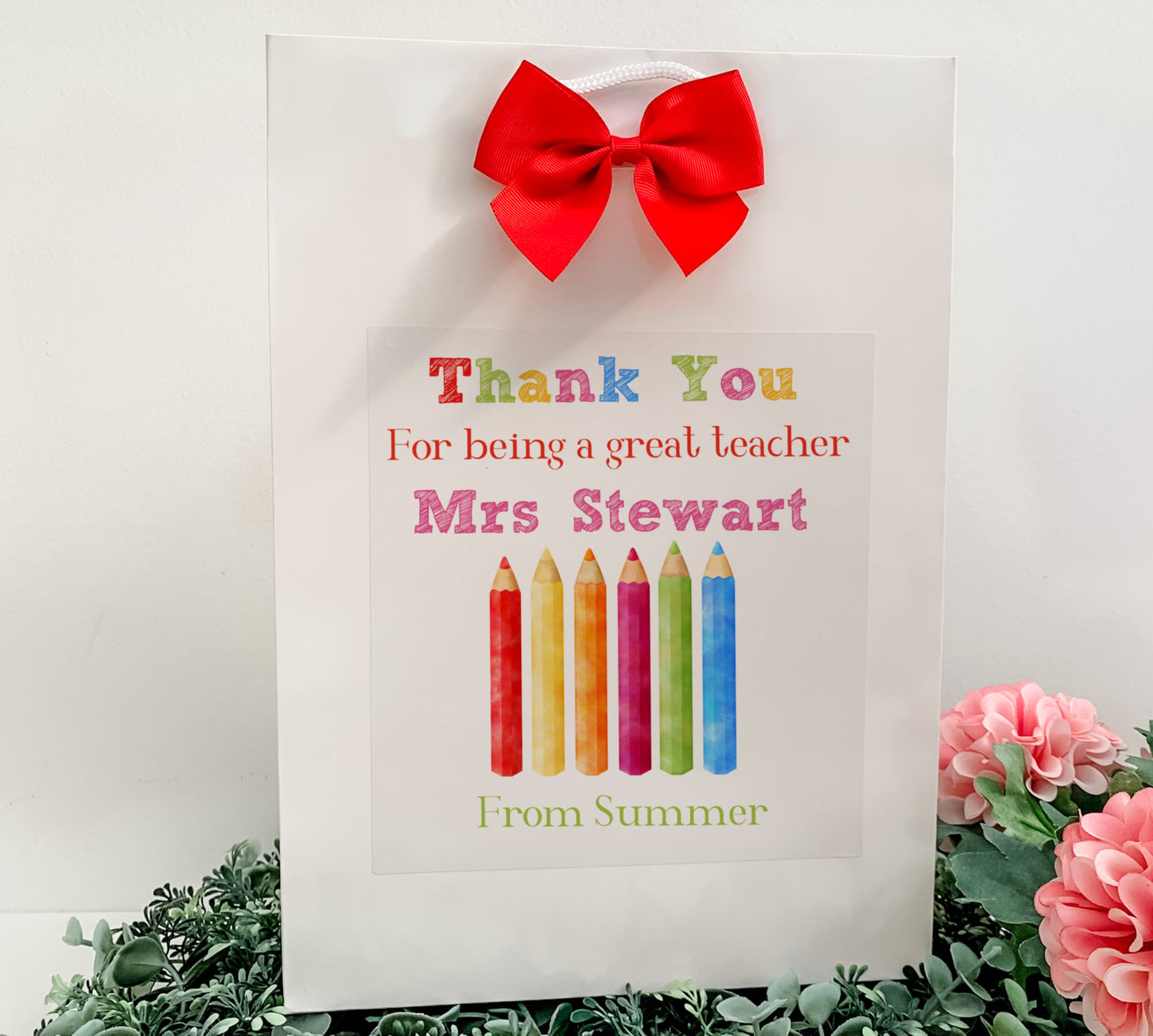 a thank you card with a red bow on it