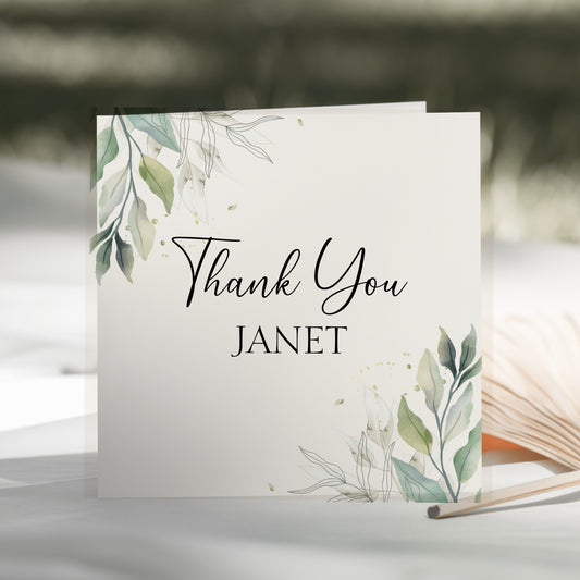 a thank you card sitting on top of an open book