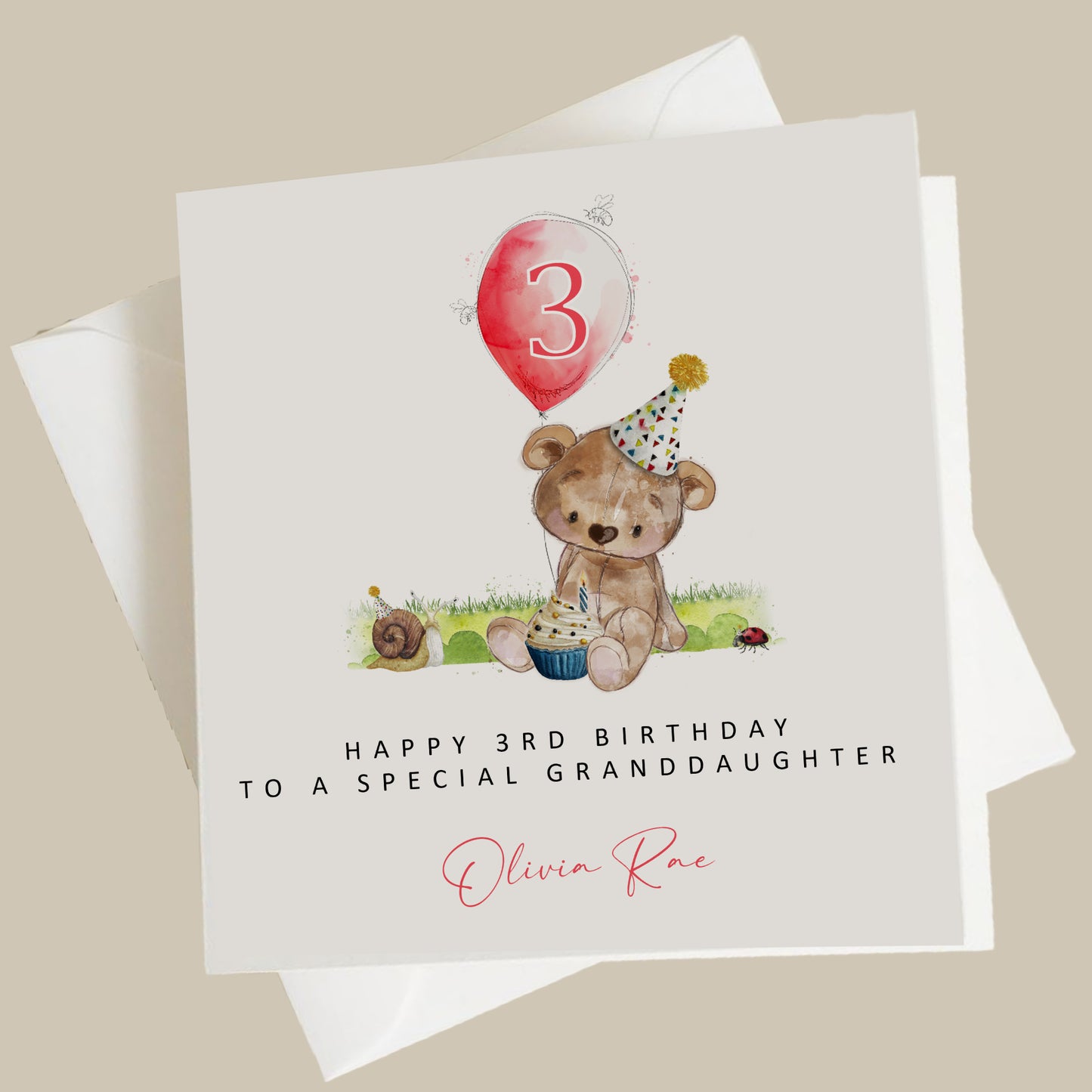 a birthday card with a teddy bear holding a cupcake