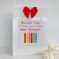 a thank you card with a red bow on top of it