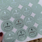 a person holding a paper with a bunch of stickers on it