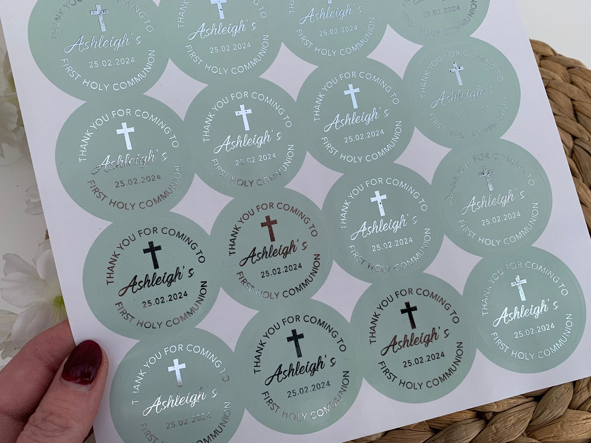 a person holding a paper with a bunch of stickers on it