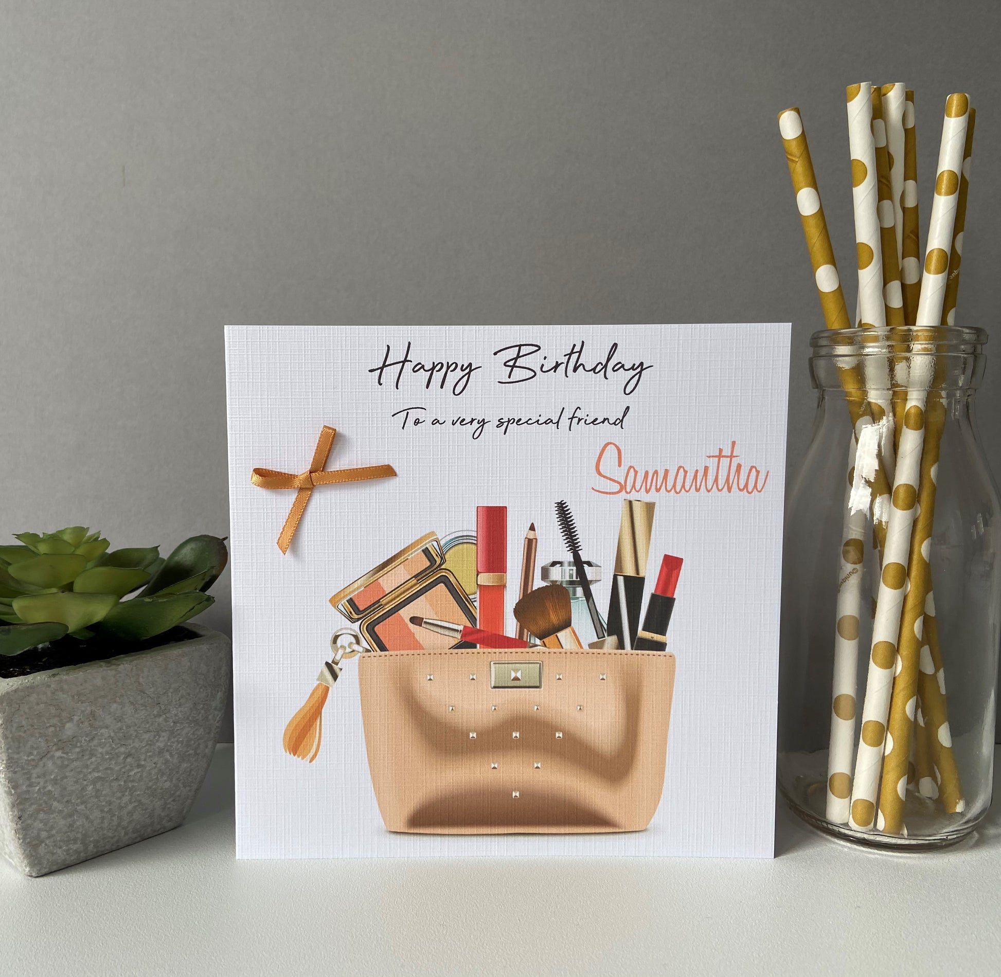 a happy birthday card with a purse of makeup