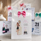 A set of personalized birthday gift bags and matching greeting cards arranged on a tabletop. The central item is a white gift bag with a large pink bow and an illustration of a woman, surrounded by other white bags and cards with pink, teal, and blue accents and birthday messages.