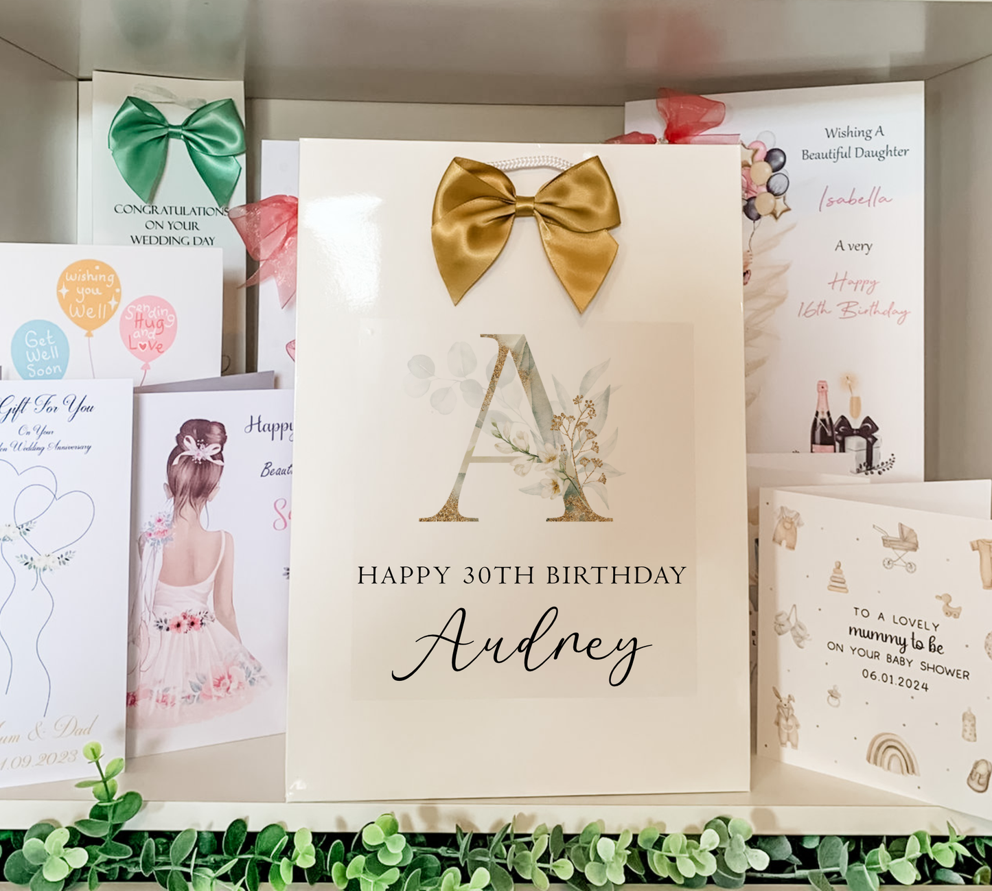 a birthday card with a gold bow on it