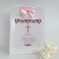 a white paper bag with a pink cross on it