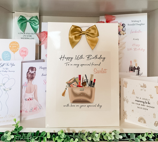 a birthday card with a gold bow on it