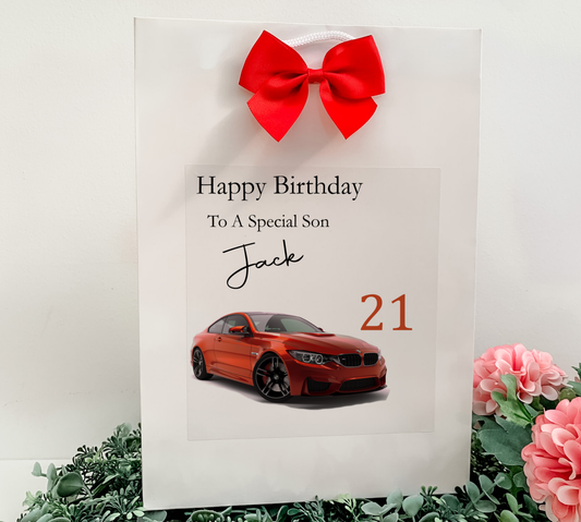 a birthday card with a red car and a red bow
