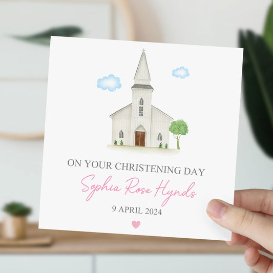 a person holding up a card with a picture of a church
