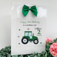 a birthday card with a tractor and a green bow