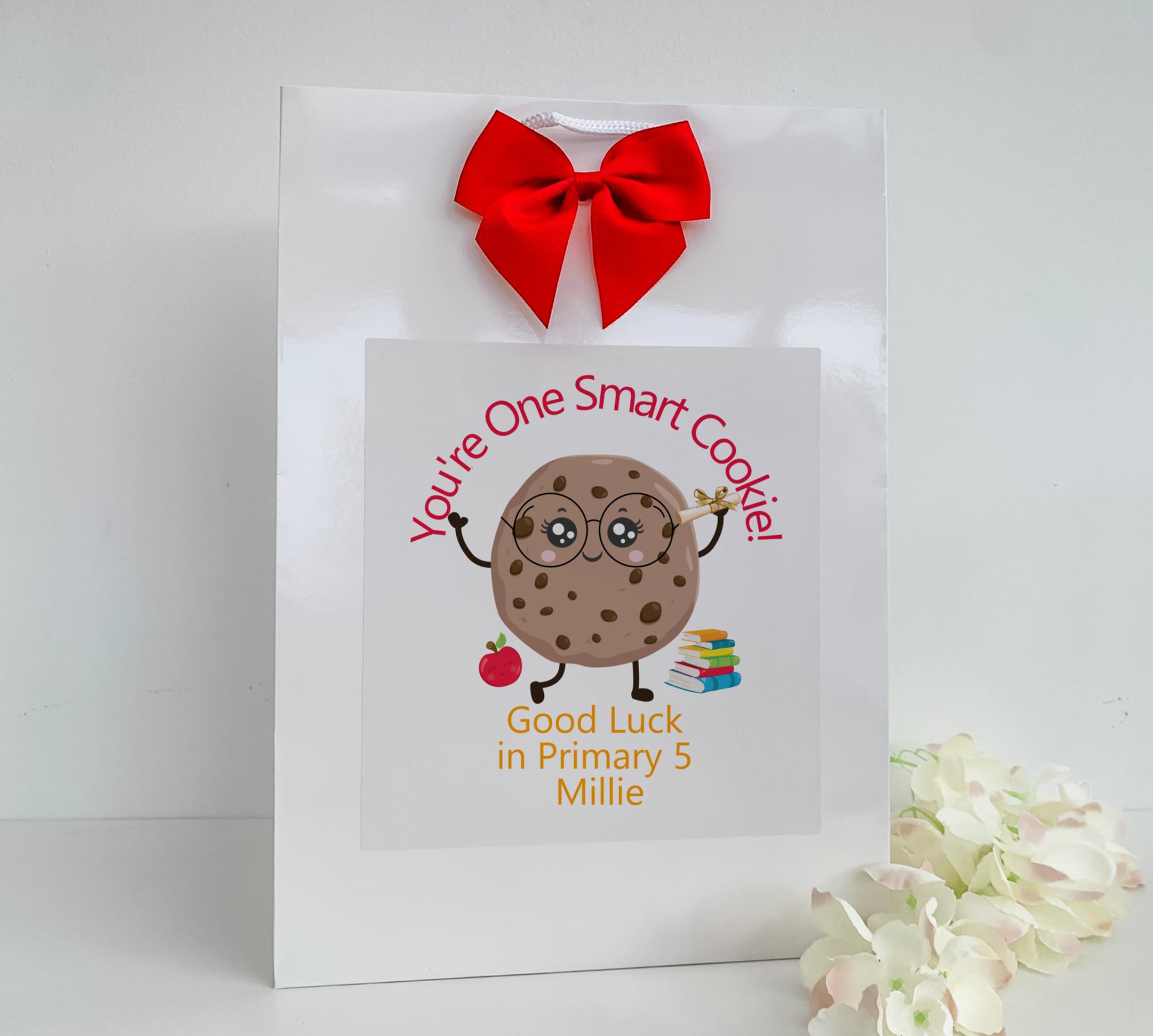 a white bag with a red bow on it