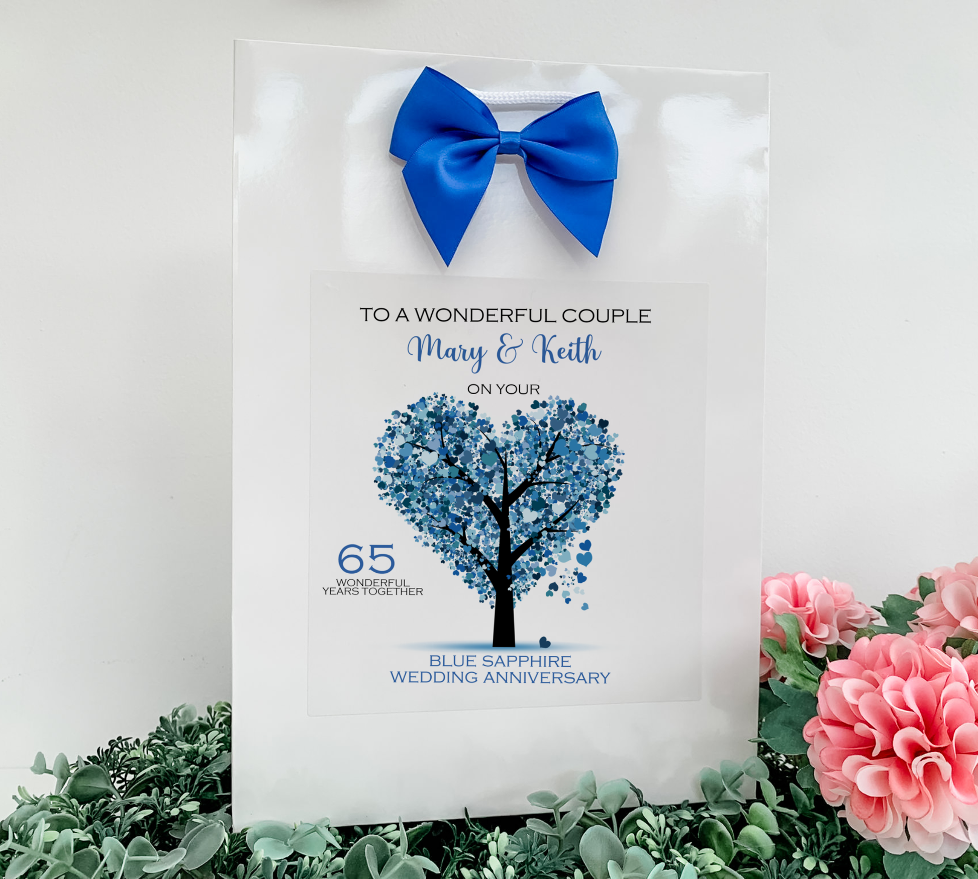 a wedding card with a blue tree and a blue bow