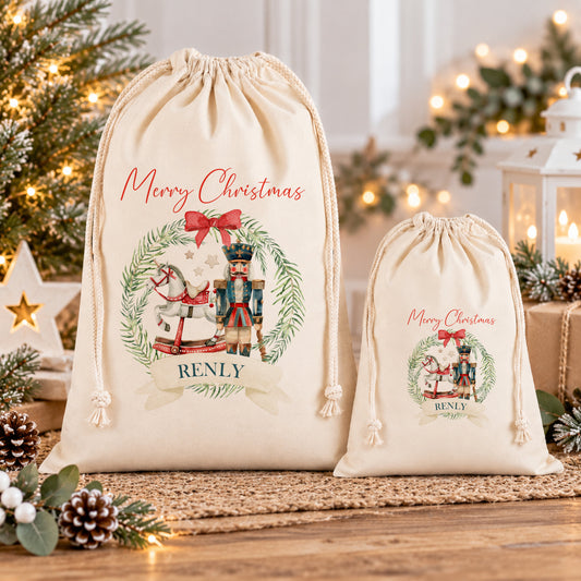 two white drawstring bags with Christmas-themed designs, placed on a wooden surface. The bags are decorated with Christmas trees, pine cones, and other holiday decorations, creating a festive atmosphere.