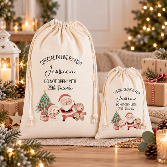 Two white drawstring bags with Christmas-themed illustrations and text, placed on a table with holiday decorations and gifts.