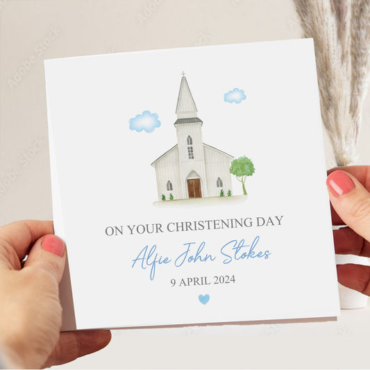 a person holding a card with a picture of a church