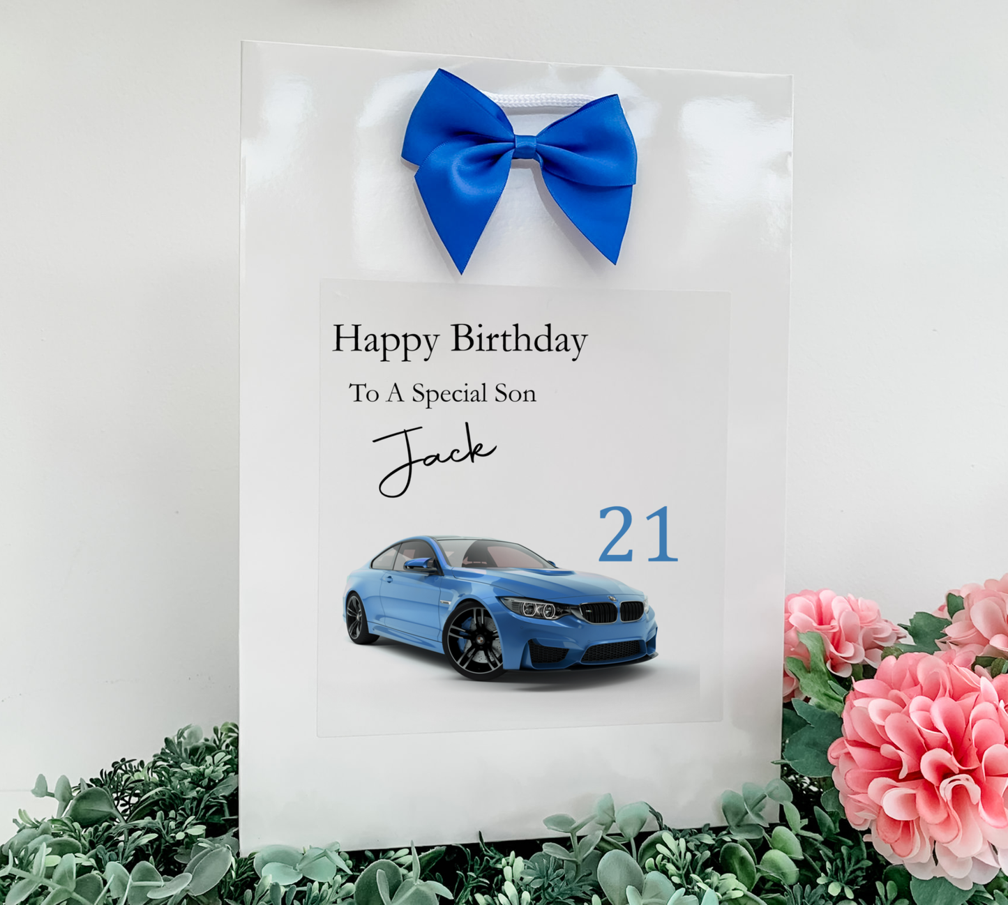 a birthday card with a blue car and a blue bow
