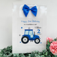 a birthday card with a tractor and a blue bow