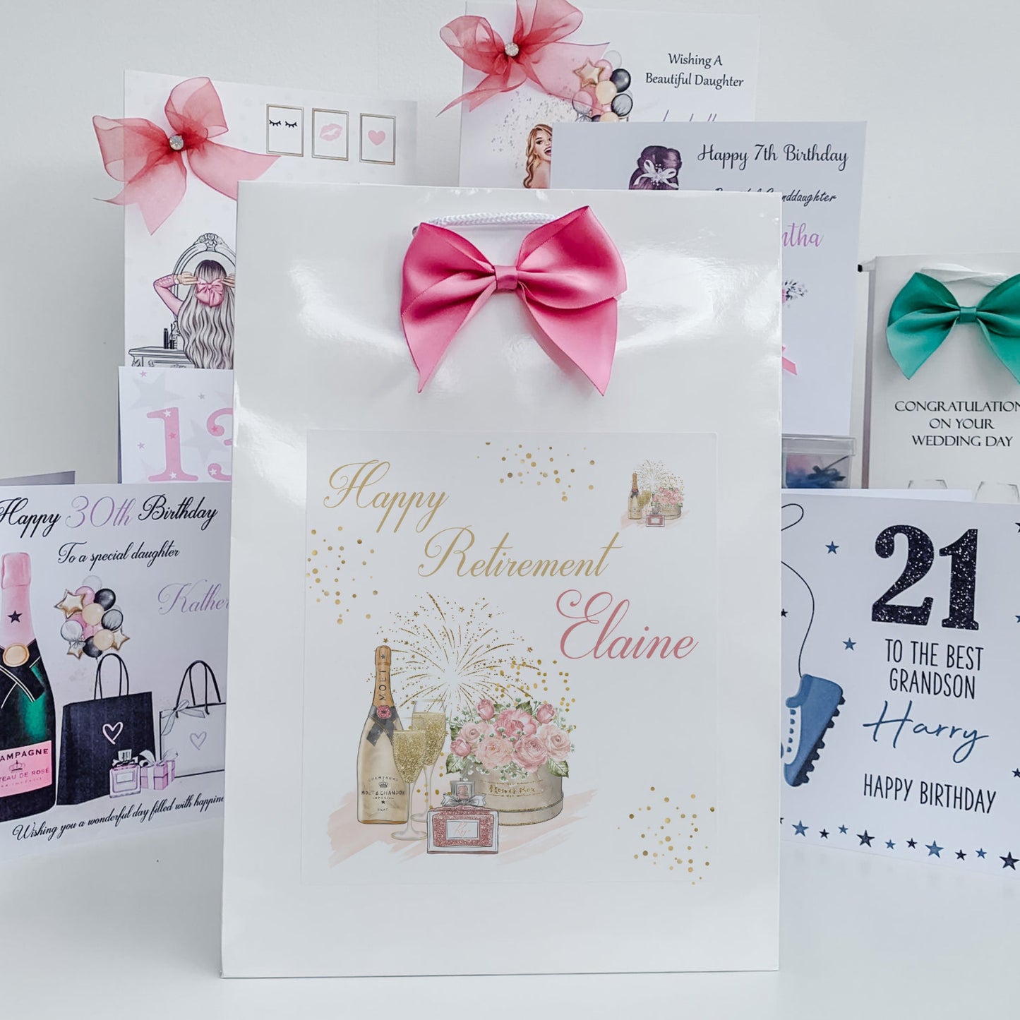 Collection of birthday and retirement cards with decorative ribbons on a white background
