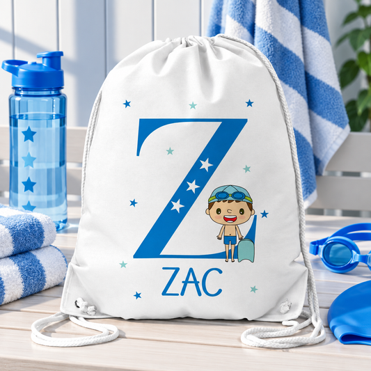 White personalised drawstring swimming bag for kids, featuring a fun blue swimmer design with a large initial and name. Perfect for swimming lessons, leisure swimming, holidays and keeping swimwear and essentials together.