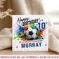 A personalized 10th birthday card for a soccer fan, featuring a soccer ball graphic surrounded by colorful paint splatters and the text any age any relationship any name'. The card is displayed on a wooden surface with draped beige fabric in the background.
