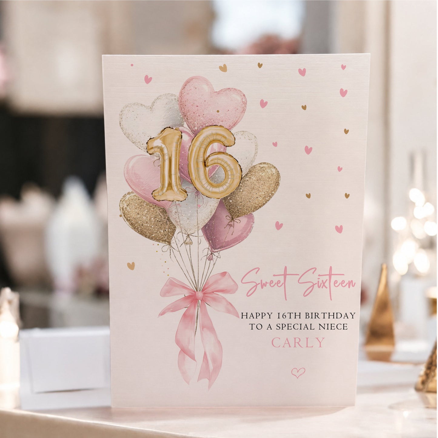 Personalised large A4 luxury Sweet 16 birthday card with pink and gold heart balloons, gold number 16 balloons, pink bow and hand-finished sparkle, customised with any name.