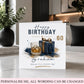 A personalized 60th birthday greeting card displayed on a marble tabletop in a modern living room setting. The white card features a dark blue and gold illustration of a whiskey glass and a gift box, with the customizable name 'Graham' at the bottom.