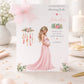 A white baby shower greeting card displayed upright in a soft pastel pink celebration setting. The card features an elegant pregnant woman wearing a flowing pink dress, surrounded by delicate pink and green floral arrangements and a decorative feathered design. The card reads “To the Fabulous Mummy to Be” and “With Love on Your Baby Shower” and features the name Amelia in pink script. The surrounding scene includes soft pastel decorations, confetti and a beautifully styled baby shower setting.