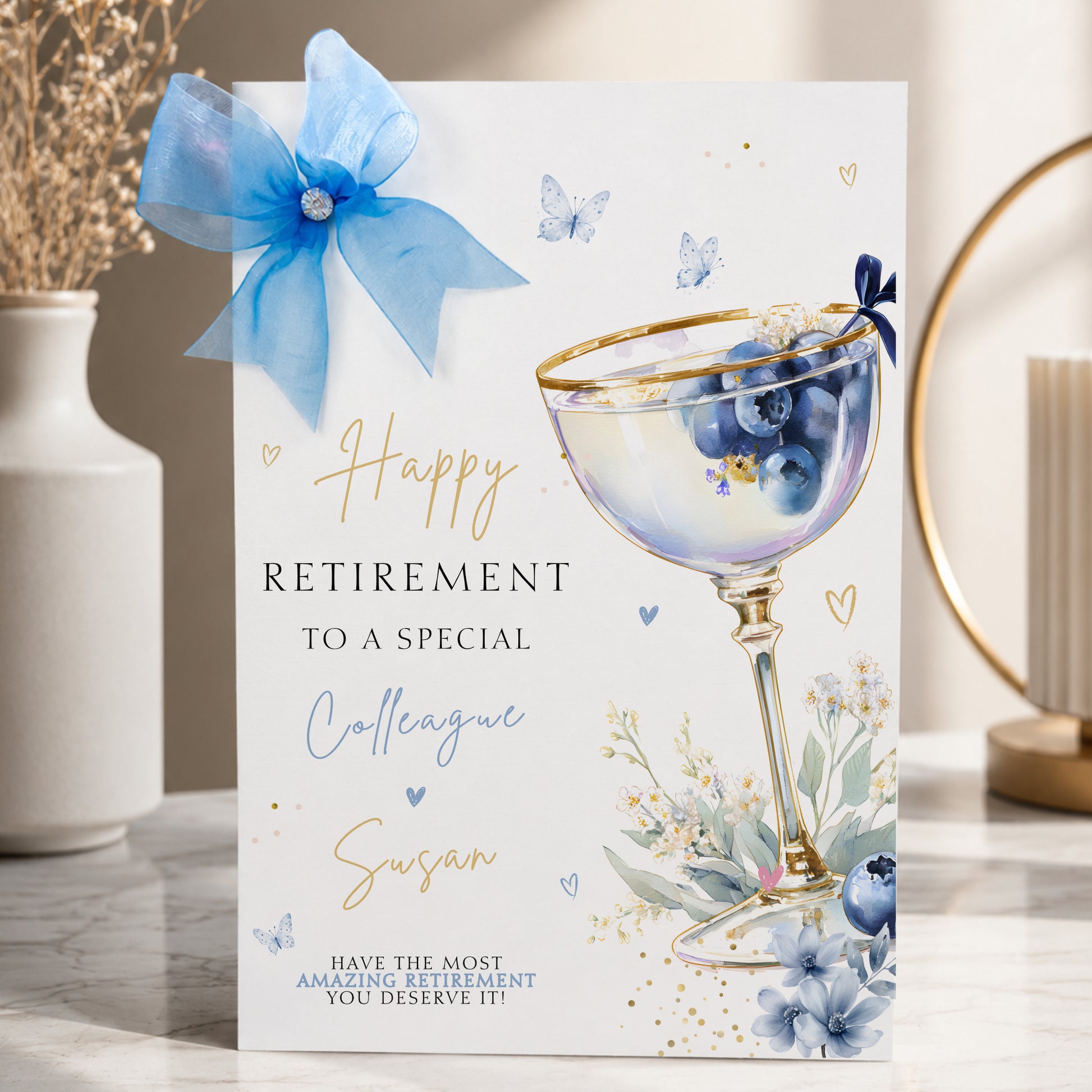 Luxury a4 large retirement card for a colleague, friend or any relationship, featuring a blueberry cocktail design hand finished with a gorgeous sparkle large organza bow and diamonte gem. This is a lovely luxury card that will stand out from the crowd.