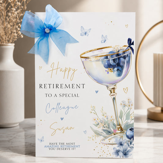 Luxury a4 large retirement card for a colleague, friend or any relationship, featuring a blueberry cocktail design hand finished with a gorgeous sparkle large organza bow and diamonte gem. This is a lovely luxury card that will stand out from the crowd.