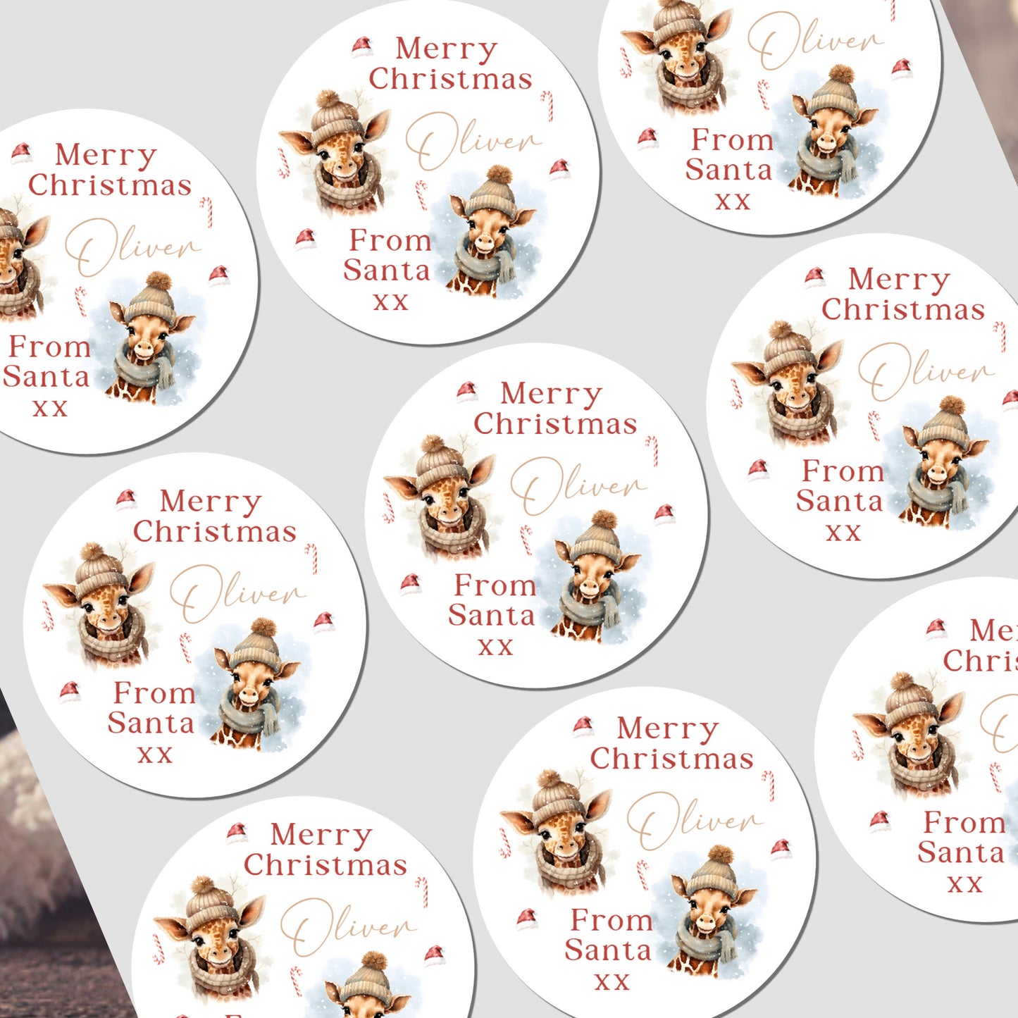 Multiple personalized Christmas stickers with a reindeer design and text on a white background.