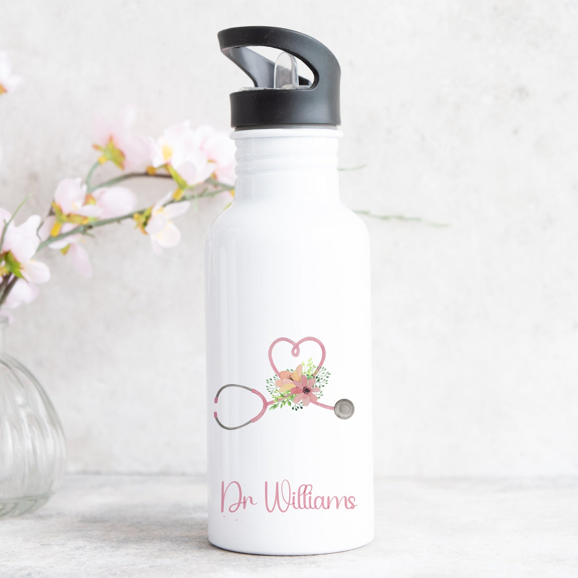 personalised water bottle with straw featuring love heart stethescope design for doctor or nurse with name on the front